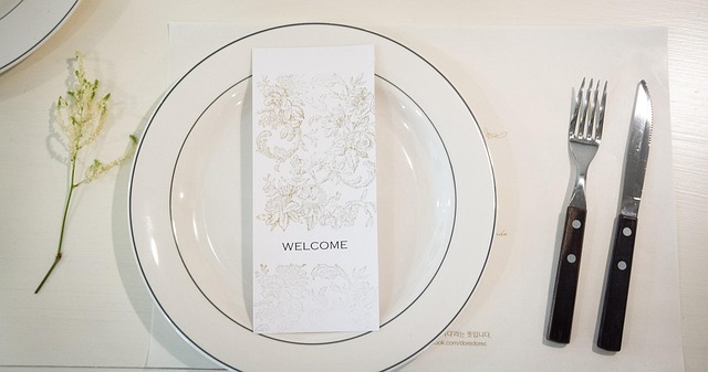 restaurant table setting with menu and water glass